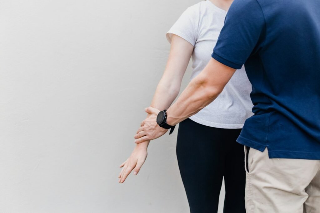 Therapist supporting a senior client during exercise